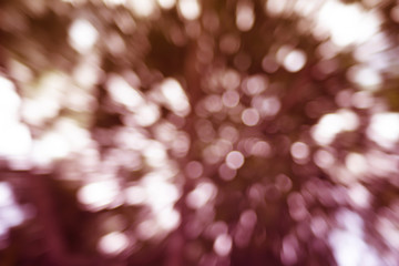 Abstract background. Distribution of white bokeh on a delicate pink background  