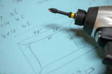 Closeup of handwritten measurements with power drill