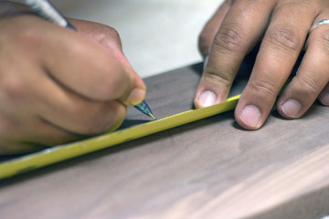 Closeup of marking a measurement on wood