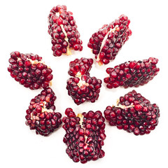 Pieces of pomegranate isolated on a white background. Top view.