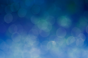 Abstract background. Distribution of white bokeh on a delicate blue background 