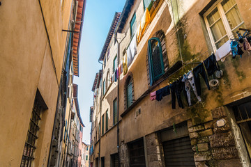 Fototapeta na wymiar Narrow streets of Lucca ancient town with traditional architecture, Italy