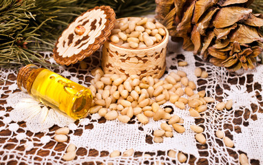 Cedar nuts, cones and oil with branch.