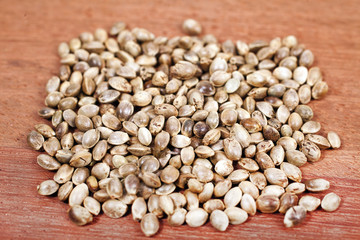 Cannabis seeds on a wooden background.