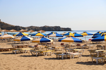 The sea coast, beach chairs and umbrellas from the sun.