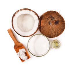 Fototapeta na wymiar Fresh cracked coconut with coconut milk in a glass and coconut meat in a wooden spoon isolated on white background.