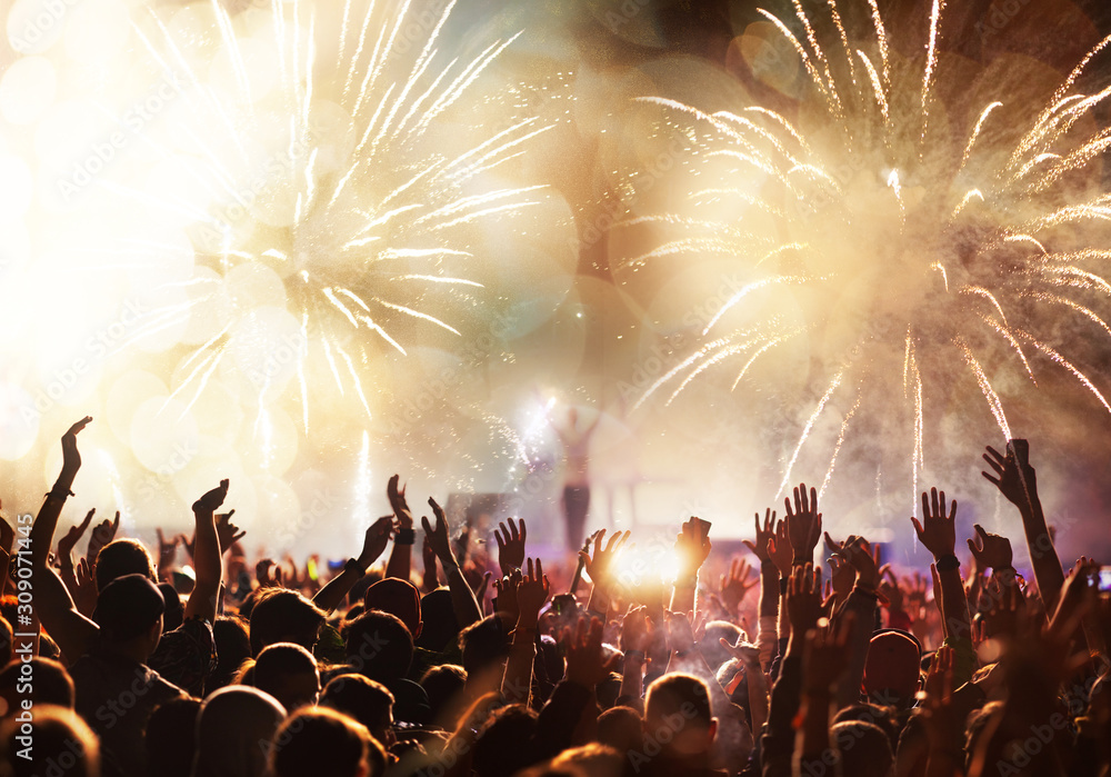 Wall mural crowd with raised hands and fireworks new year banner