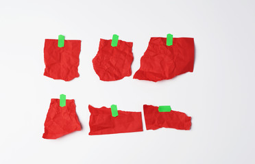various empty red pieces of paper stuck with green velcro