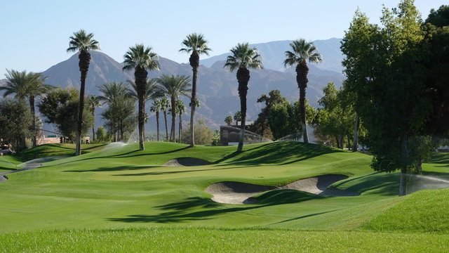 View of desert golf course with palms and sand traps