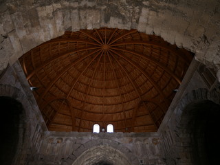 Interior and wooden roof of the ruin of an impressive building resembling a mosque within the Roman ruins of the citadel of Amman, capitol of Jordan