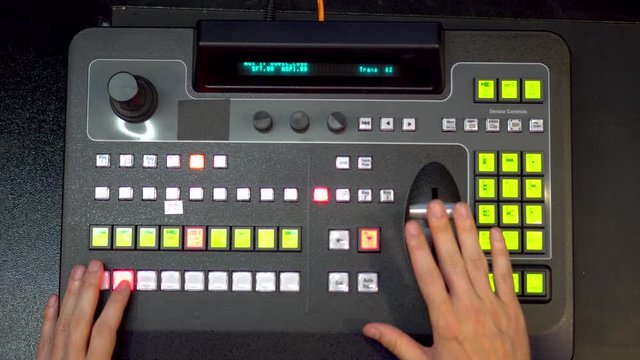 Broadcast stream from video switcher console mixer with mens hands