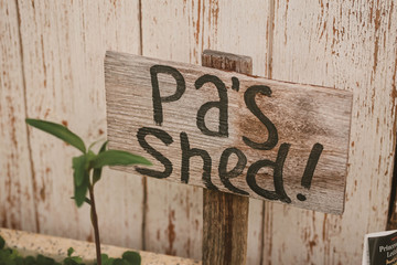 Pa's Shed painted wooden sign in cottage garden