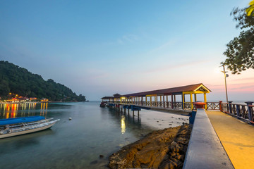Pulau Perhentian, Terengganu - August 14th, 2018  : Beautiful view of small Perhentian Island with multiple boats during blue hour. Image contains noise and soft focus