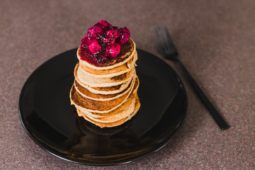 vegan banana pancakes stack with exotic dragonfruit coulis on top