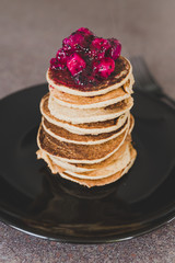 vegan banana pancakes stack with exotic dragonfruit coulis on top