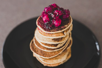 vegan banana pancakes stack with exotic dragonfruit coulis on top
