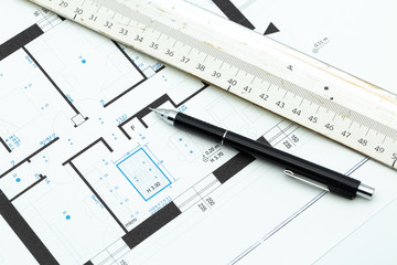 Roll of architectural blueprint house building plans on table with pencil and ruler. Home Automation building concept - Powered by Adobe