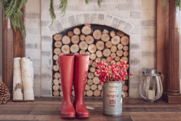 Winter home background with boots in front of the fireplace