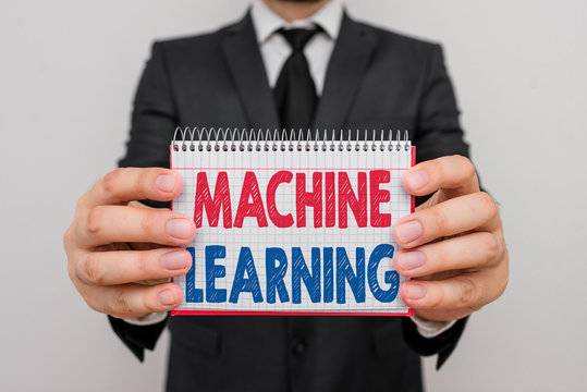 Writing note showing Machine Learning. Business concept for scientific study of algorithms and statistical models Male human wear formal work suit with office look hold book