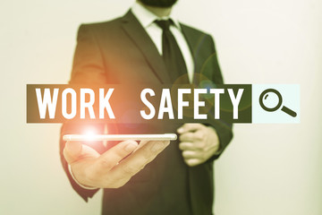 Handwriting text Work Safety. Conceptual photo policies and procedures in place to ensure safety in workplace Male human wear formal work suit hold smart hi tech smartphone use one hand