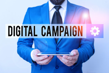 Text sign showing Digital Campaign. Business photo text effort put forward by a company to drive engagement Businessman in blue suite with a tie holds lap top in hands