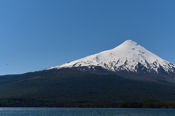 Fototapeta premium The Osorno volcano seen from Ensenada near Puerto Varas in South Chile. Nature and blue sky.