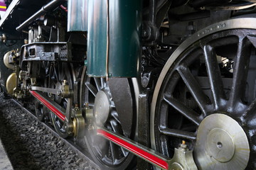 Bangkok,Thailand-December 5, 2019: Driving wheels and coupling rods on a steam locomotive made in Japan