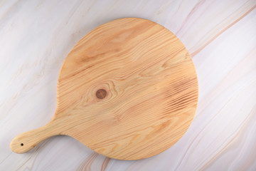 Wooden cutting board on a gray marble background