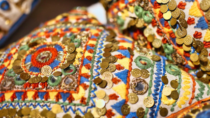 Fototapeta na wymiar close up on a home decor cushion with Indian or middle eastern colors and textiles