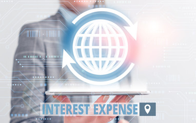 Conceptual hand writing showing Interest Expense. Concept meaning cost of debt that has occurred...