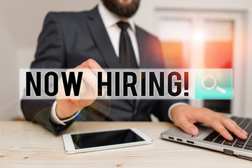 Word writing text Now Hiring. Business photo showcasing finding evaluating working relationship with future employees Male human wear formal clothes present presentation use hi tech smartphone