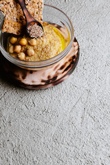 Chickpea hummus with sesame on white wooden board, top view. Vegan food