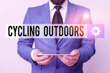 Text sign showing Cycling Outdoors. Business photo text sport or technique of riding or racing on a bicycle Businessman in blue suite with a tie holds lap top in hands