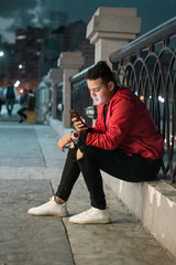 young man out in the street at night 