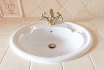 Fototapeta premium beautiful white sink with a bronze tap