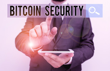 Writing note showing Bitcoin Security. Business concept for funds are locked in a public key cryptography system Male human wear formal work suit hold smartphone using hand