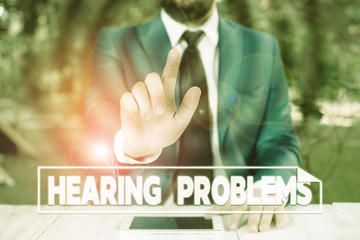 Writing note showing Hearing Problems. Business concept for partial or total inability to hear Hearing impairment Businessman with pointing finger in front of him