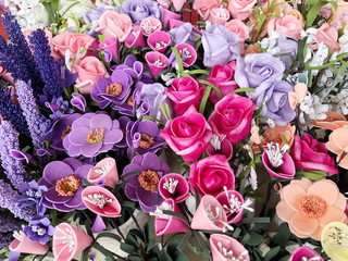 Background of bright colorful artificial flowers. Close up.