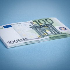 Euro cash on a blue and pink background. Euro Money Banknotes. Euro Money. Euro bill. Place for text.