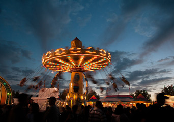 long exposure of a swing ride at a state fair at twilight toned with a retro vintage instagram...
