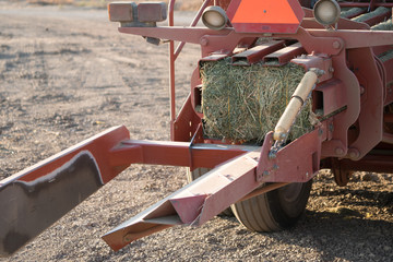 red hay alfalfa bailing tractor with bail finished. 