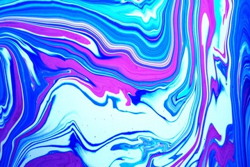 Bright abstract marble pink and blue background. Acrylic paint flows freely and creates an...