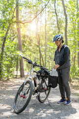 Fototapeta na wymiar Senior asian woman riding bikes in park with hold map on trip