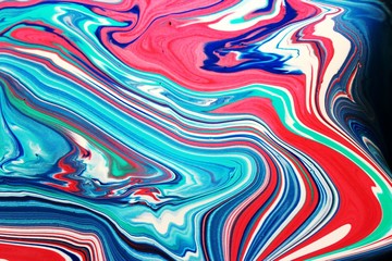 Bright abstract marble red-black-blue background. Acrylic paint flows freely and creates an...