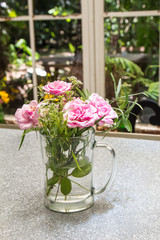 Beautiful flower arrangement in glass vase on the table