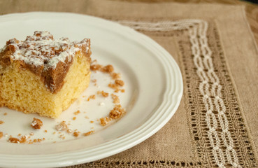 Single piece of coffee crumb cake served on a white plate