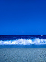 Classic blue seashore. Beautiful beach with big waves