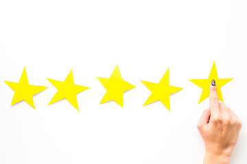 Positive feedback, good service concept. Hand touch the best star on white background top-down copy space