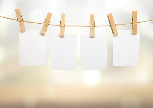 Hanging empty white card frame on a rod with background