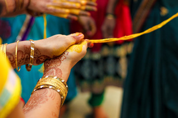 Indian Traditional Wedding: women hand in haldi ceremony 